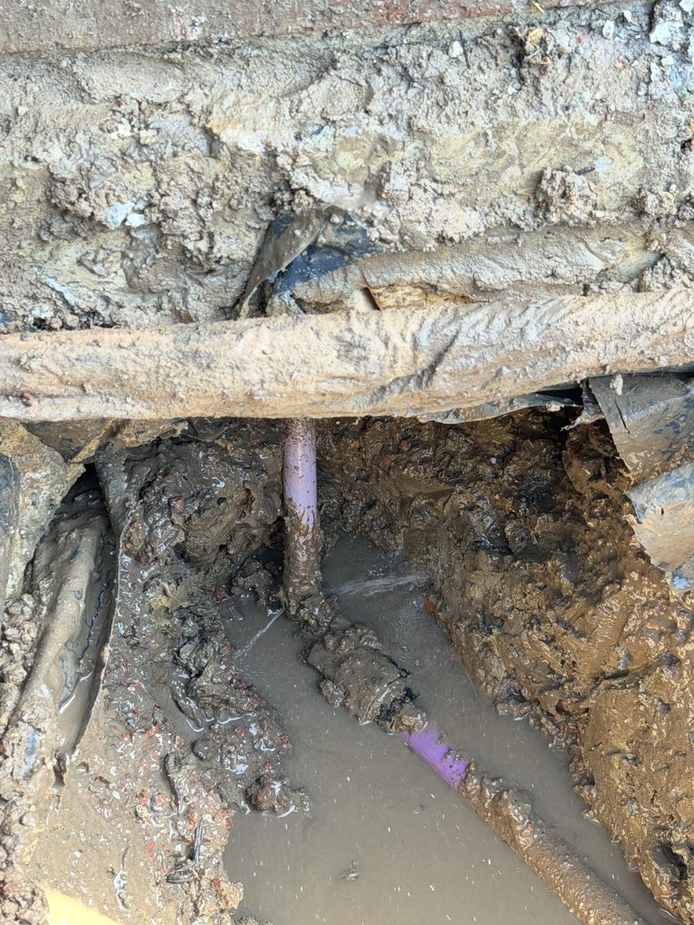 Recycled water pipe exposed beneath concrete during a hidden leak repair in Clyde